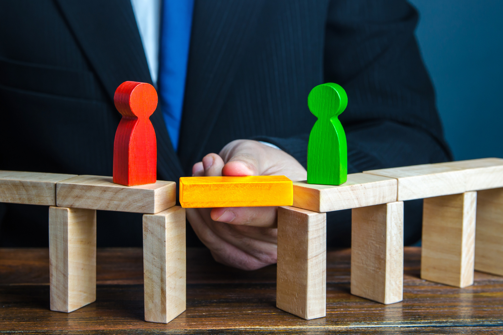 Mediating legal disputes – symbolic image of dispute resolution with figures being brought together, representing Martin Shepherd Solicitors in Hertfordshire and North London.