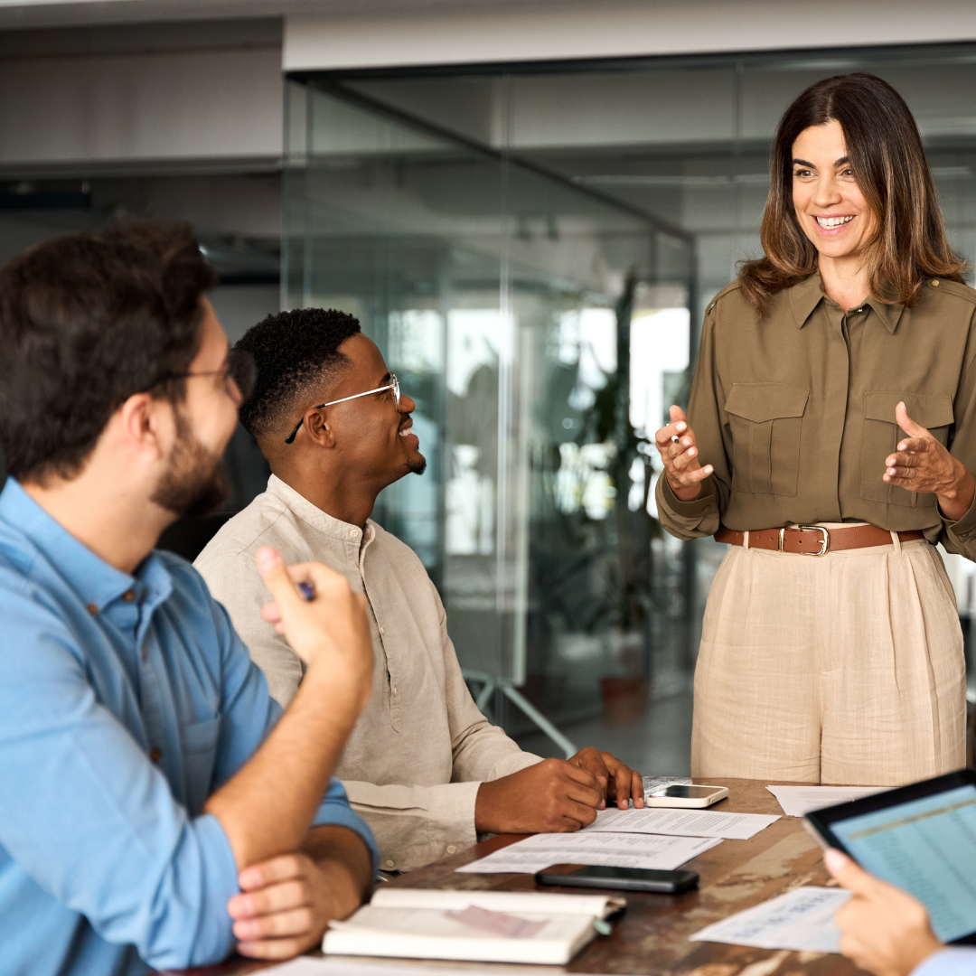 Confident female business leader addressing colleagues during a meeting, reflecting the supportive approach of Martin Shepherd Solicitors for clients in Potters Bar, Hertford, Finchley, North London, and Hertfordshire.