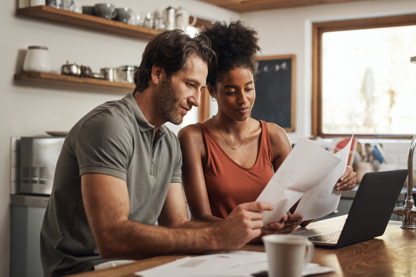 Couple reviewing documents at home with Martin Shepherd Solicitors in North Finchley, Potters Bar and Hertford for pre-nuptial and post-nuptial agreements.