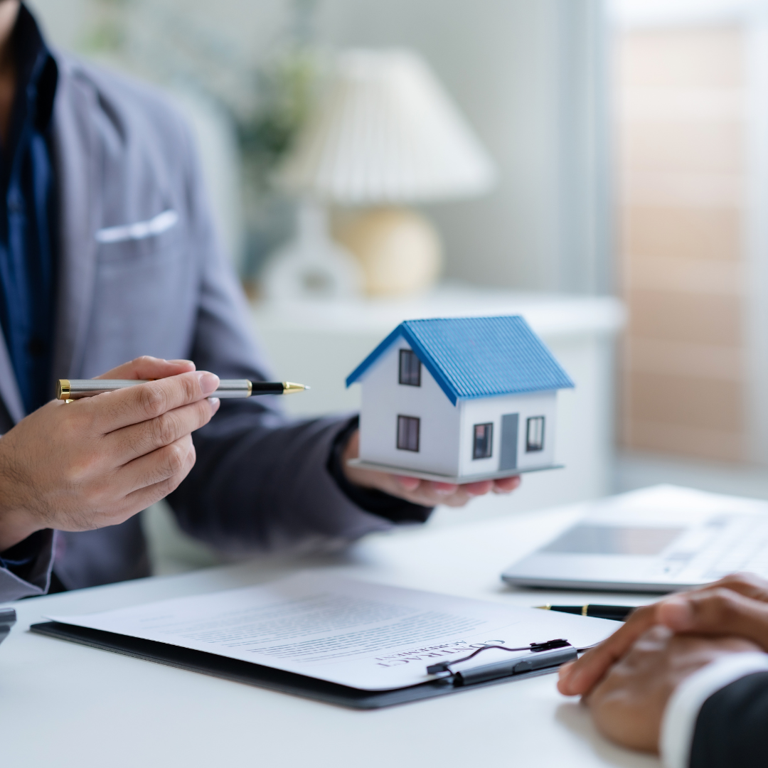 Solicitor showing a model house during a client meeting representing inheritance tax planning, property transfer and asset distribution advice by Martin Shepherd Solicitors in Potters Bar, Hertford and North Finchley.