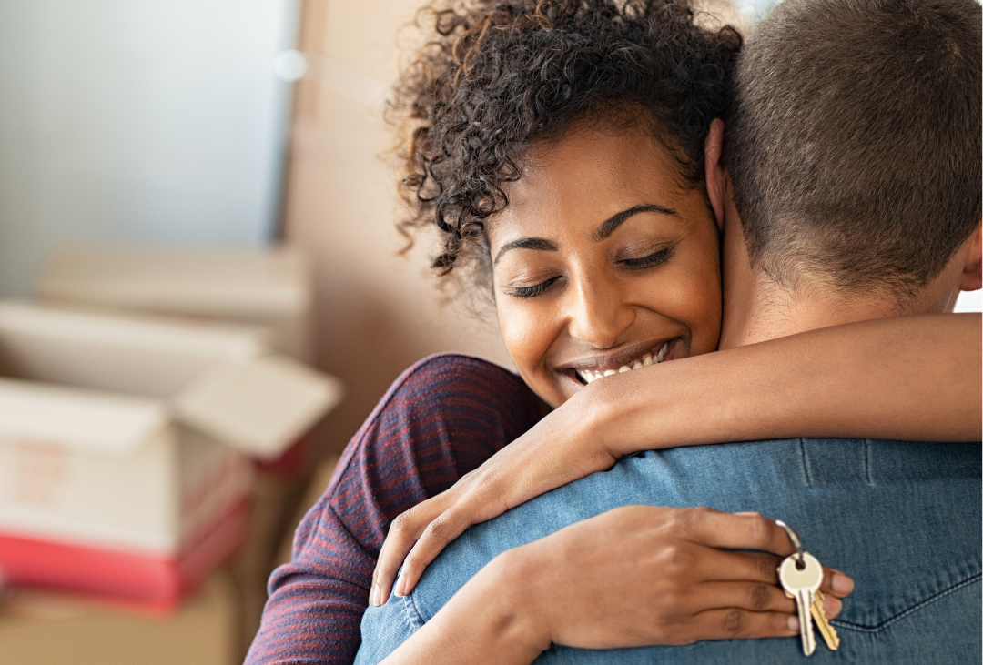 Couple embracing after completing their home move with the support of Martin Shepherd Solicitors’ conveyancing team in Finchley, Potters Bar or Hertford
